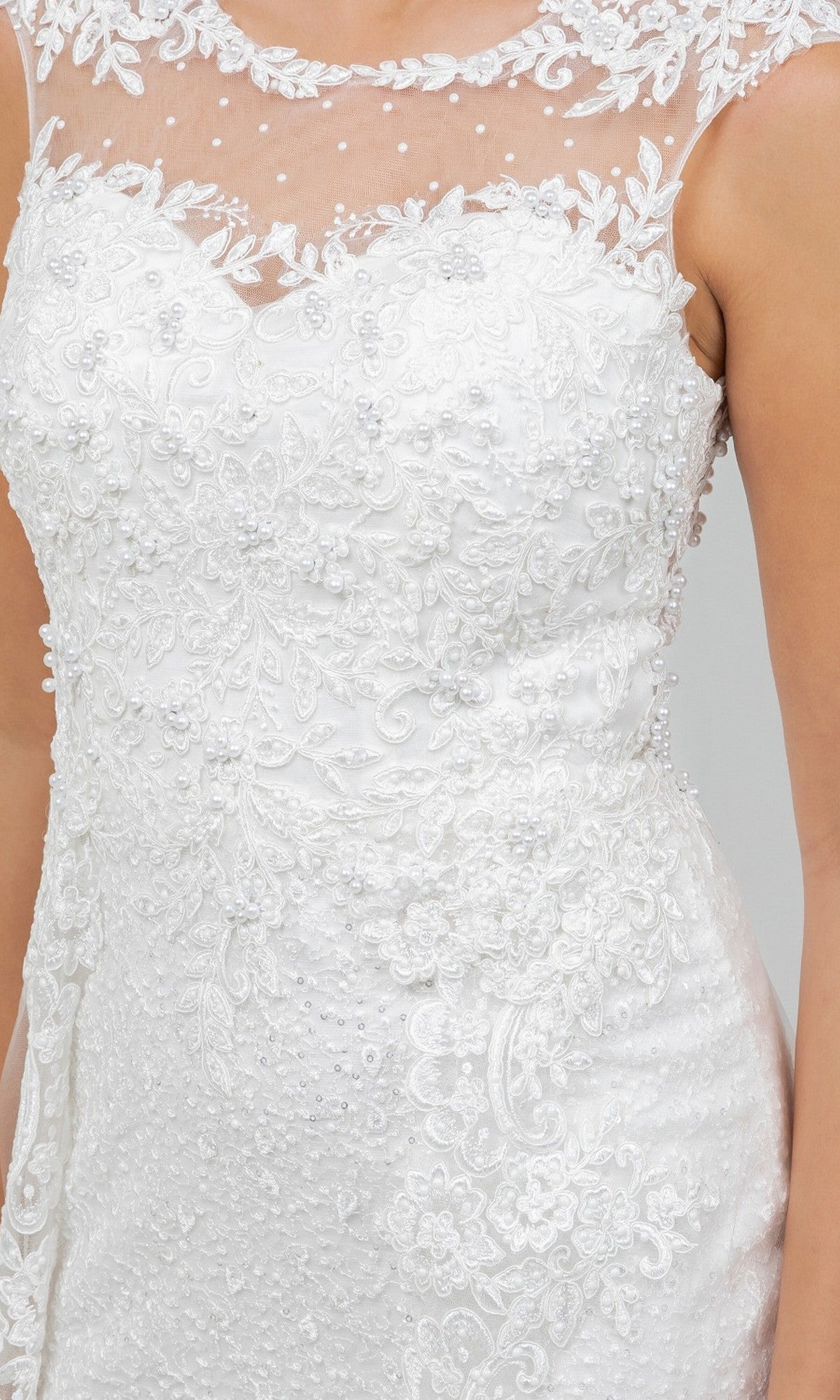 Close-up of the Cinderella Couture 8506J Long Formal Dress, showcasing its white lace construction with floral embroidery and beaded details. The gown features delicate tulle fabric along the sheer neckline and a sleeveless design, while intricate lace appliques add an elegant touch to this formal wedding dress.